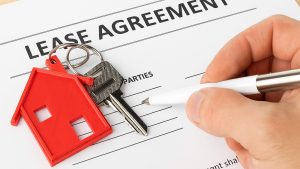 Signing a lease agreement in Dubai with house keys on the table